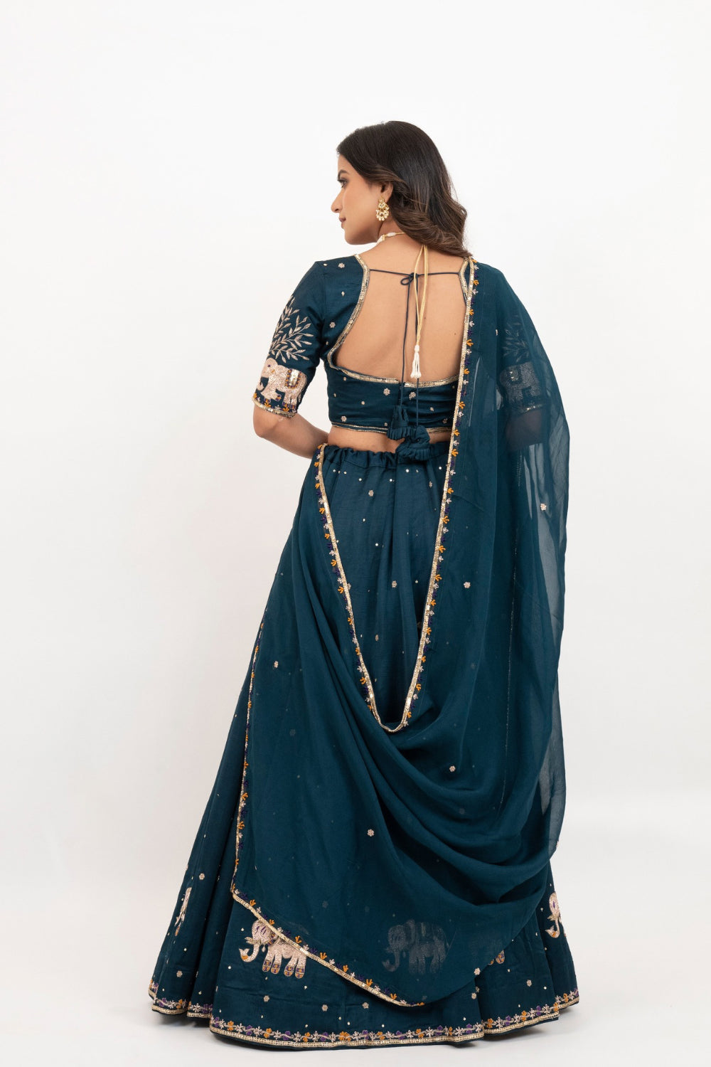 Peacock blue soft silk zardozi embroidered lehenga choli with hand cut dana work