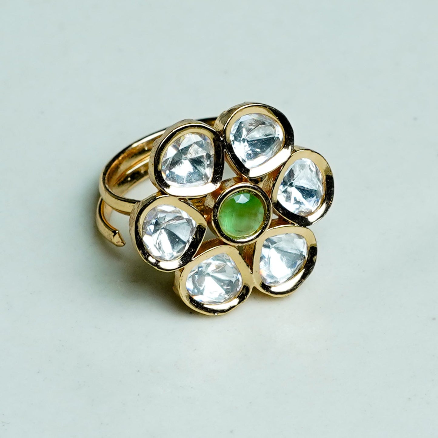 Zevar Club Gold-Toned White Kundan Studded Floral Adjustable Ring with Green Center Stone