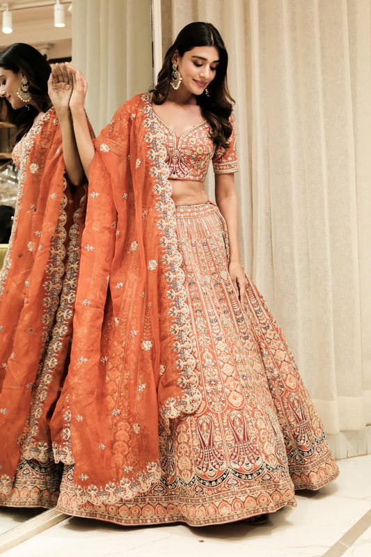 Orange silk lehenga choli with aari and sequins work